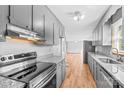 Kitchen features gray cabinets, granite countertops, and stainless steel appliances at 539 Bethlehem Rd, Statesville, NC 28677