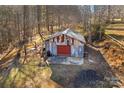 Rustic metal workshop with a roll-up door, situated in a wooded area at 539 Bethlehem Rd, Statesville, NC 28677