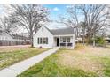 Quaint white house with a porch, yard, and trees at 621 Flint St, Rock Hill, SC 29730