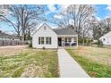 White house with a walkway and mature trees at 621 Flint St, Rock Hill, SC 29730