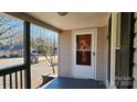 Front porch with wooden railings and a white door at 830 Richard Ave, Kannapolis, NC 28081