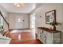 Inviting foyer with hardwood floors, staircase, and decorative entryway furniture at 109 Chanticleer Ct, Charlotte, NC 28214