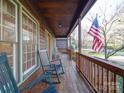 Relaxing front porch with rocking chairs and American flag at 12 Woodvine Ln, Clover, SC 29710