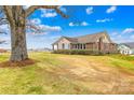 Quaint brick home featuring a large tree in the front yard, providing ample shade and curb appeal at 1212 Coddle Creek Hwy # 35, Mooresville, NC 28115
