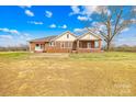 Brick home with a rear patio, perfect for outdoor entertaining and enjoying the expansive backyard at 1212 Coddle Creek Hwy # 35, Mooresville, NC 28115