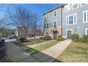 Three-story townhome with gray siding and a side yard at 1304 Queen Lyon Ct, Charlotte, NC 28205