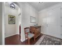Bright entryway with hardwood floors, antique furniture, and a view to another room at 13146 Heath Grove Dr, Huntersville, NC 28078