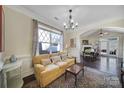 Living Room with hardwood floors, yellow couch, and access to the dining area at 13146 Heath Grove Dr, Huntersville, NC 28078