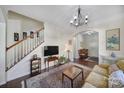 Living room features hardwood floors, a staircase, and an open floor plan at 13146 Heath Grove Dr, Huntersville, NC 28078