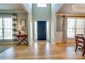 Bright entryway with hardwood floors and a dark blue front door at 13836 Ballantyne Meadows Dr, Charlotte, NC 28277