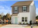 Two-story townhome with gray siding, light-colored trim, and a teal front door at 205 Cliffwood Nw St # B-2, Concord, NC 28027