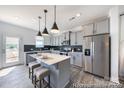 Modern kitchen featuring stainless steel appliances and a stylish center island at 205 Cliffwood Nw St # B-2, Concord, NC 28027