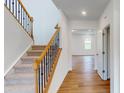 Elegant staircase with wrought iron railing leading to the second floor at 254 Winford Rd, Troutman, NC 28116