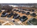 Community overview showcasing numerous houses near a lake at 6420 Barcelona Way, Charlotte, NC 28214