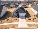 Single-story home with a gray roof and a two-car garage at 6420 Barcelona Way, Charlotte, NC 28214