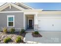 Gray house with stone accents and a two-car garage at 6420 Barcelona Way, Charlotte, NC 28214