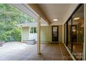 Spacious patio with tiled flooring, offering serene views of surrounding trees at 825 W Ketchie St, China Grove, NC 28023