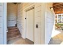 Exterior condo entry with stairs and elevator access at 921 Northeast Dr, Davidson, NC 28036