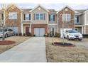 Front view of townhome community, showcasing a driveway and landscaping at 9408 Hamel St, Charlotte, NC 28215