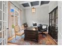 Home office featuring coffered ceilings, a large window, a decorative chandelier, and an executive desk at 1024 Adkins Rd, York, SC 29745