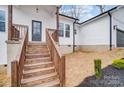 View of a well-built home with a wooden staircase leading up to the front door at 118 Stockbridge Ln, Statesville, NC 28677
