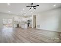 Open living room with a central island, lots of natural light, and vinyl plank flooring at 118 Stockbridge Ln, Statesville, NC 28677