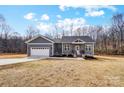 Beautiful single-story house boasts an attached garage and a well-manicured lawn at 122 Stockbridge Ln, Statesville, NC 28625