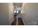 Bright entryway with dark hardwood floors and view to living room at 138 Lanyard Dr # B, Mooresville, NC 28117