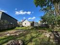 Large backyard featuring a fire pit, a small shed, a privacy fence, and plenty of shade at 2824 N Brevard St, Charlotte, NC 28205