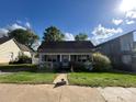 Charming single story home with a covered porch, well-maintained lawn, and blooming azalea bushes at 2824 N Brevard St, Charlotte, NC 28205
