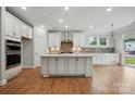 Spacious kitchen with a large island, stainless steel appliances, and white cabinets offer a sleek design at 4003 Grace Pointe Dr # 99, Wesley Chapel, NC 28079