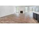 Spacious living room with hardwood floors and a fireplace at 4003 Grace Pointe Dr # 99, Wesley Chapel, NC 28079