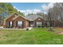 Brick ranch house with a landscaped yard and driveway at 416 Zelkova St, York, SC 29745
