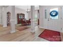 Elegant foyer with hardwood floors, decorative columns, and a view into the dining area, perfect for welcoming guests at 416 Zelkova St, York, SC 29745