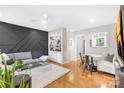 Open living room with gray sectional sofa and built-in shelving at 419 Wakefield Dr # A, Charlotte, NC 28209