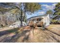 Tan colored house with wooden deck and steps, next to another home at 504 E Poplar St, Dallas, NC 28034