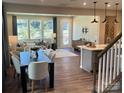 Open concept living and dining area with hardwood floors and large windows at 5626 De Vere Dr, Indian Land, SC 29707
