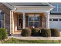 Inviting front porch with bench and landscaping, leading to the home's entrance at 7922 Sardis Creek Ln, Charlotte, NC 28270