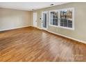 Spacious living room featuring light hardwood floors and neutral walls at 8003 Regent Park Ln, Charlotte, NC 28210