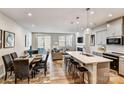 Open concept kitchen with island, white quartz countertops, and gray cabinets at 8008 Downy Oak Ln, Charlotte, NC 28269