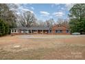 Brick ranch house with a long driveway and landscaping at 9330 Bellhaven Blvd, Charlotte, NC 28214