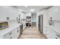 Modern kitchen with white cabinets, quartz countertops, and stainless steel appliances at 111 Oakmont Rd, Stanley, NC 28164