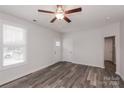 Living room with hardwood floors, neutral walls, and a view of the front yard at 13331 Central Ave, Huntersville, NC 28078