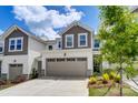 Two story townhome with taupe garage door and landscaping at 14926 Tamarack Dr, Charlotte, NC 28278