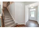 Modern staircase with carpet runner and wrought iron railing at 14930 Tamarack Dr, Charlotte, NC 28278