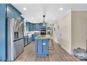 Modern kitchen featuring a center island, stainless steel appliances, and stylish blue cabinets at 549 Dairy Rd, Troy, NC 27371