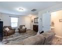 Bright living room with two armchairs, a half bath, and entryway at 6307 Pennacook Dr, Charlotte, NC 28214