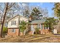 Ranch style home with a brick exterior, mature trees, and a spacious yard at 7401 Kilcullen Dr, Charlotte, NC 28270