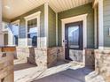 Inviting front door with glass panes and brick porch at 1000 Lily Pond Cir, Waxhaw, NC 28173