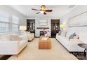 Spacious living room with a fireplace, built-in shelving, and hardwood floors at 1000 Lily Pond Cir, Waxhaw, NC 28173